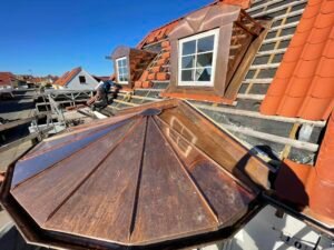 Copper roof construction with dormer windows.