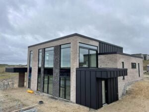 Modern brick house under cloudy sky