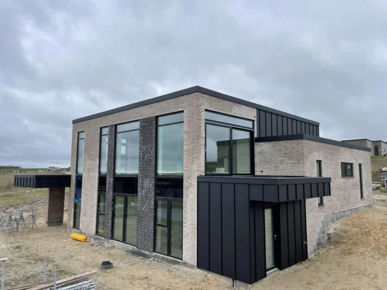 Modern brick house under cloudy sky