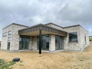Modern brick house with large windows.