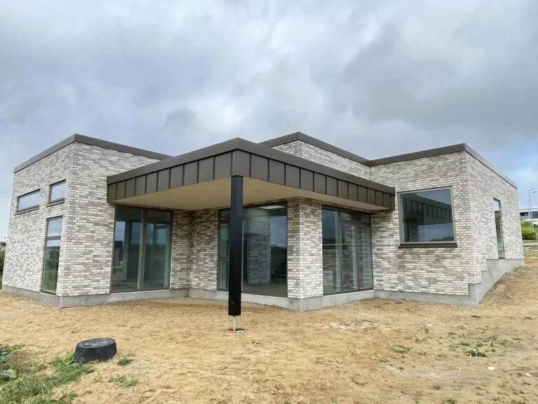 Modern brick house with large windows.