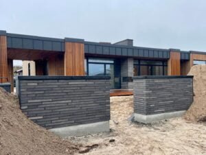 Modern house under construction with wooden accents.