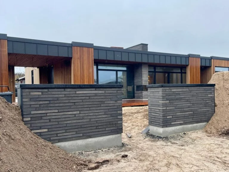 Modern house under construction with wooden accents.